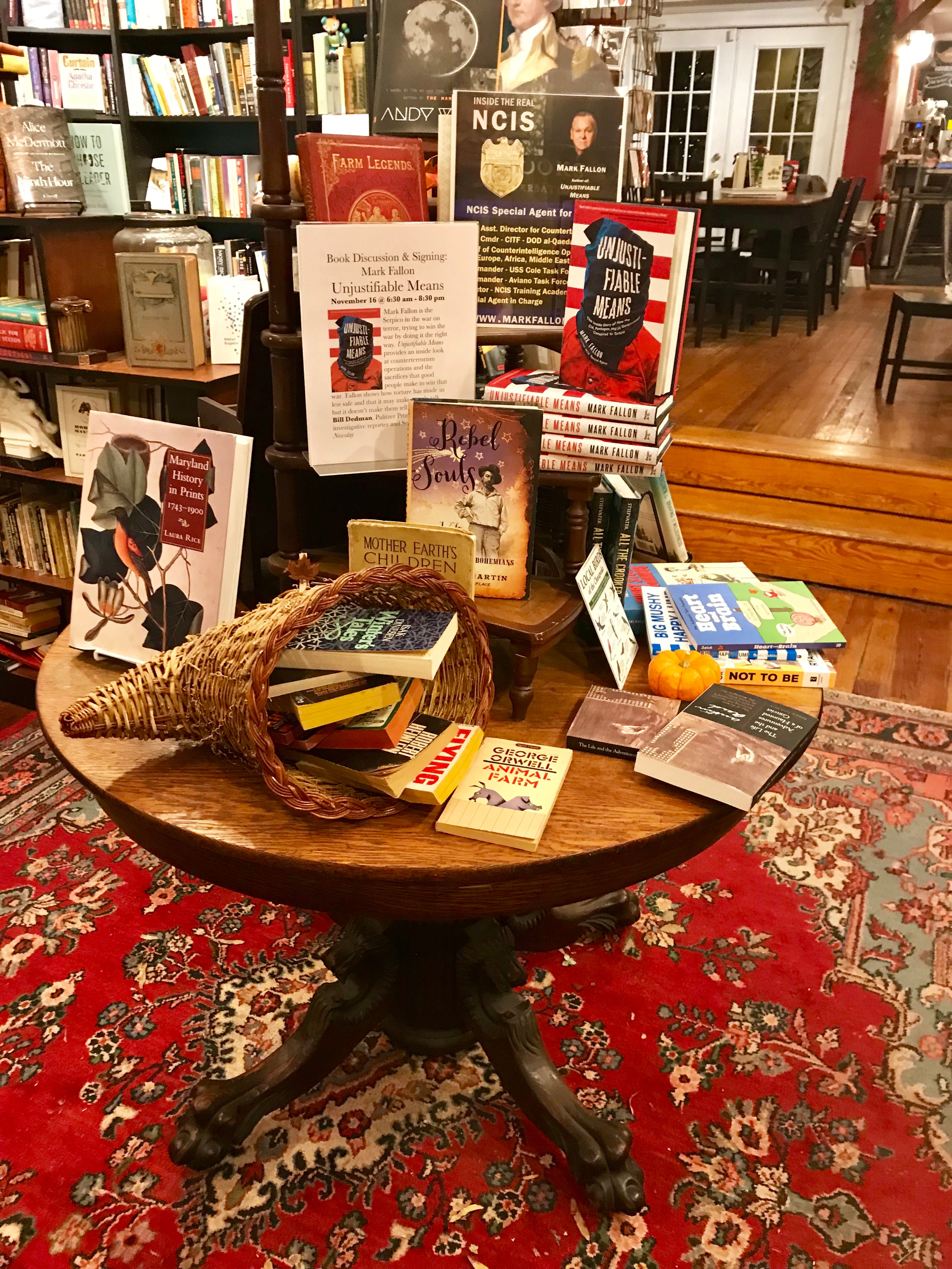 Unjustifiable Means featured on a bookstore display table alongside other titles