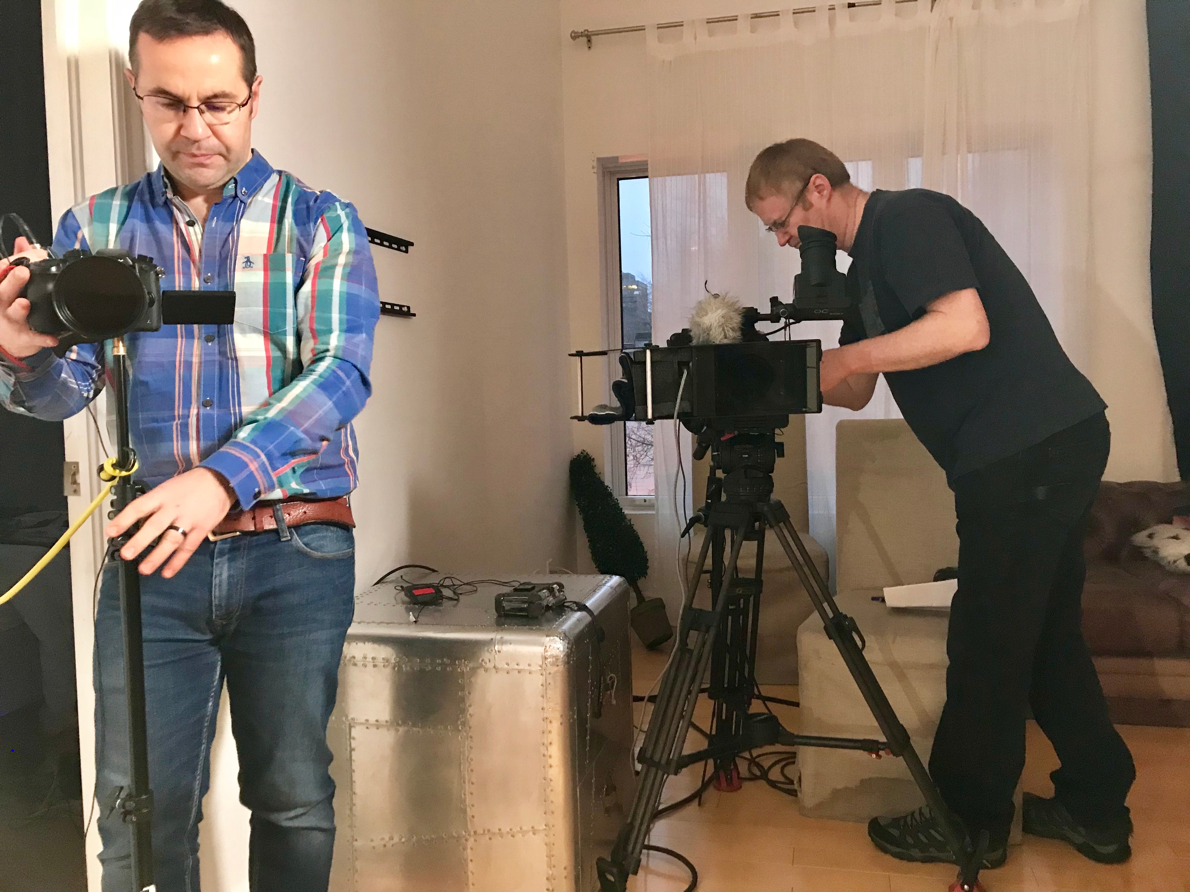 Documentary film crew setting up cameras and equipment on location