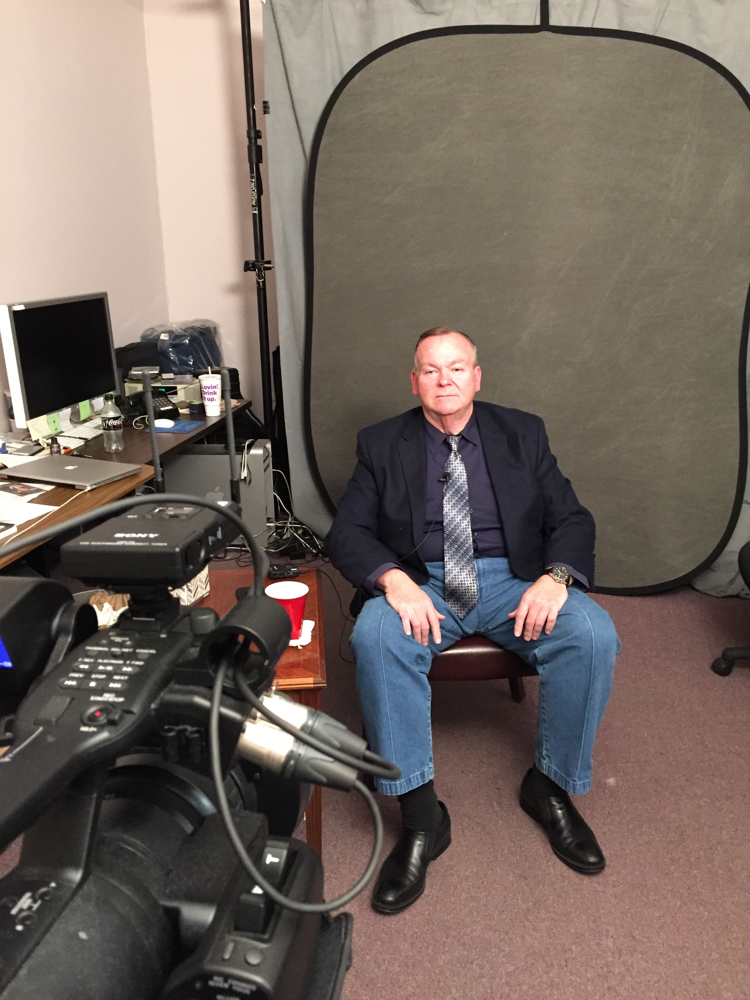 Mark Fallon being filmed by a TV camera crew on location